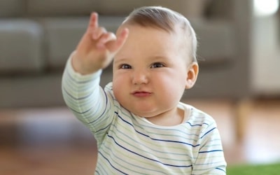 A baby signing to use the potty
