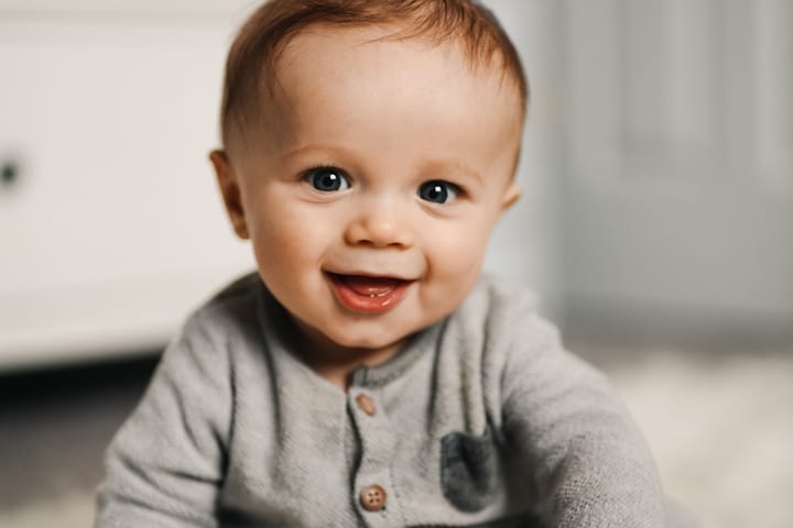 A six month old baby smiling and having fun