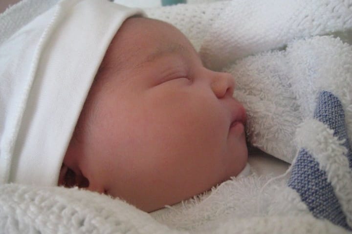 A newborn baby sleeping peacefully